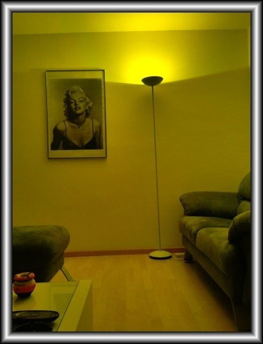 indoors, transfer print, auto post production filter, yellow, wall - building feature, home interior, door, wall, sitting, human representation, animal representation, one person, art and craft, window, art, chair, one animal, creativity, relaxation, pets