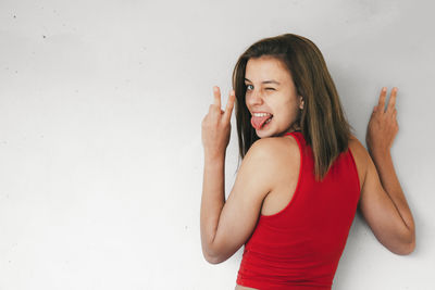 Portrait of a smiling young woman against white background