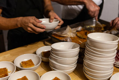 Midsection of man preparing food on table