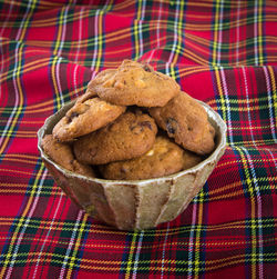 Close-up of cookies in bowl on tablecloth