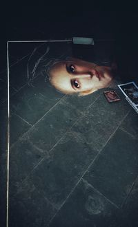 Portrait of young woman lying on floor