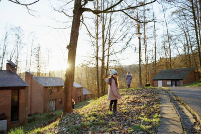 Rear view of girl walking on country road 