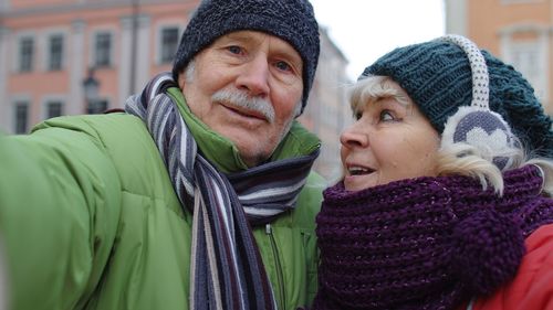 Senior couple standing outdoors during winter