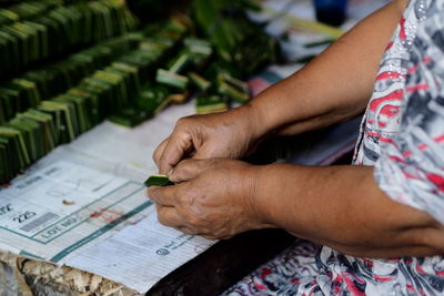 High angle view of woman hand holding paper