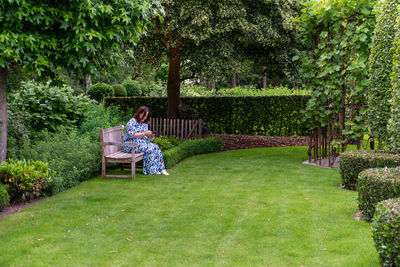 People sitting on bench in yard