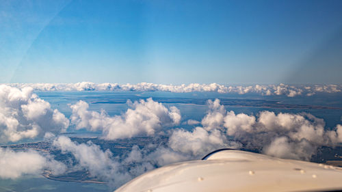 Panoramic view of airplane flying against sky