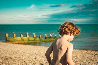 Boy playing on the beach on a sunny day