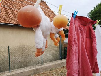 Clothes drying on clothesline against orange wall