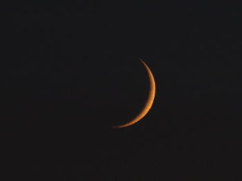 Low angle view of moon against sky at night