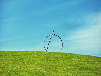 Scenic view of grassy field against cloudy sky