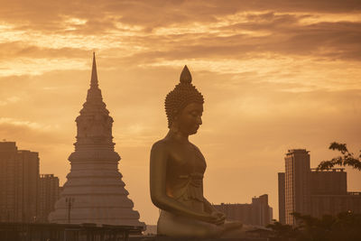 Low angle view of statue against sky during sunset