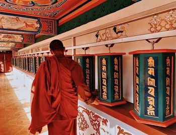 Rear view of man standing at temple