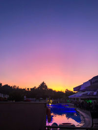 Scenic view of swimming pool against sky during sunset