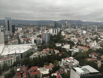 High angle view of buildings in city against sky