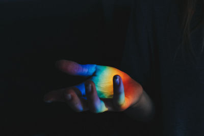 Close-up of human hand against black background