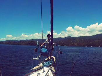 Sailboat in sea against sky