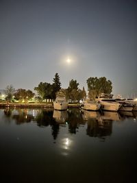 Scenic view of lake against sky at night