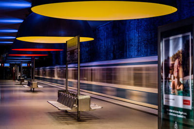 Blurred motion of train at railroad station platform during night