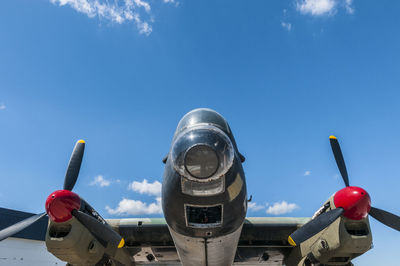 Low angle view of airplane against blue sky
