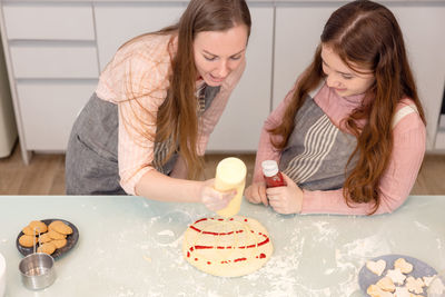 Young woman preparing food in kitchen at home