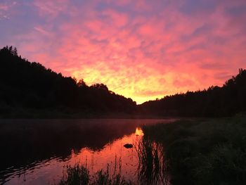 Scenic view of lake against romantic sky at sunset