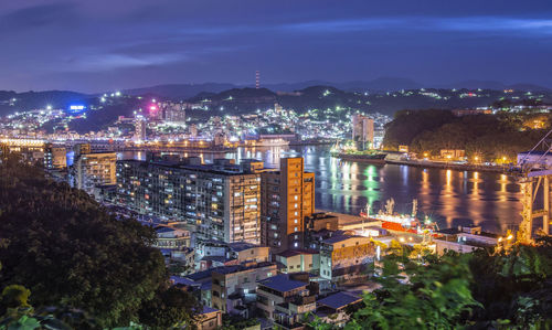 High angle view of illuminated bridge and buildings at night