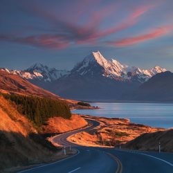 Scenic view of snowcapped mountains against sky during sunset