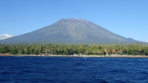 Scenic view of mountain against blue sky