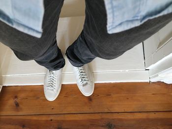 Low section of woman standing on tiled floor