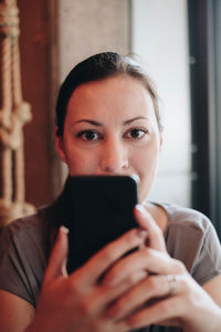 Woman using mobile phone in home