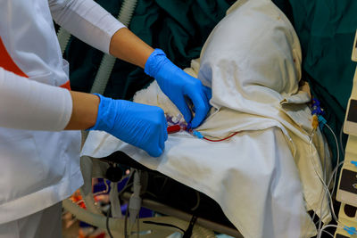 Midsection of doctor treating patient in operating room