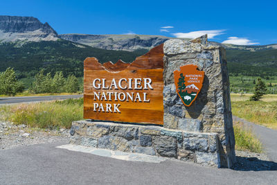 Information sign on road against mountain range