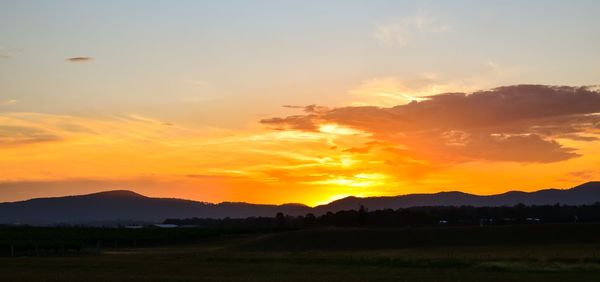 Scenic view of mountains against sky at sunset