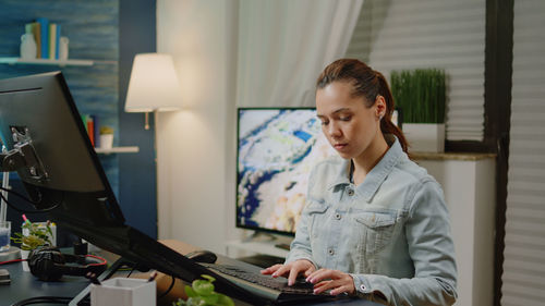 Young woman using computer at office