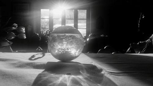 Close-up of crystal ball on table at home