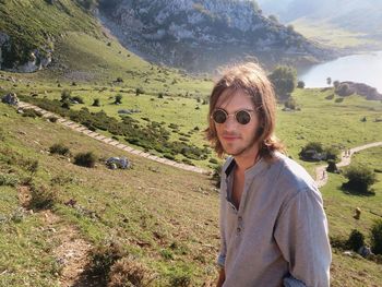 Portrait of man wearing sunglasses on field