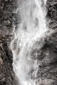 Waterfall cascading on steep cliff