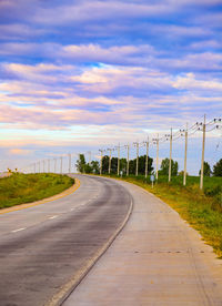 Empty road along countryside landscape