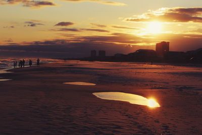 Scenic view of beach against sky during sunset