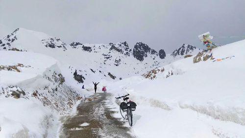 People skiing on snowcapped mountains during winter