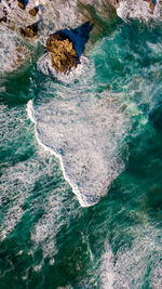 High angle view of rocks in sea