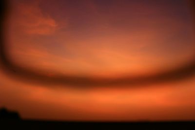 Scenic view of sea against orange sky