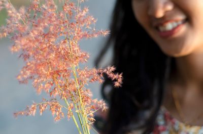 Close-up of young woman with flower tree