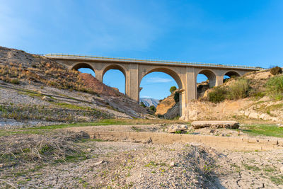 Bridge over a dry river, mountainous nature and drought environment.