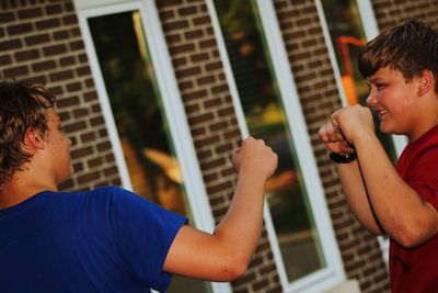 Boys giving fist bumps