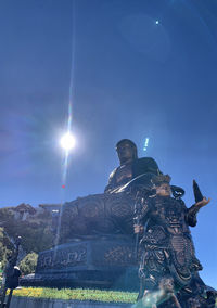 Low angle view of sculpture against sky