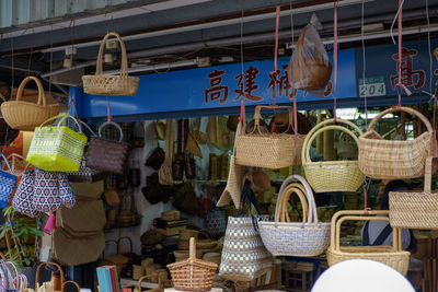 Clothes hanging in basket for sale at market stall