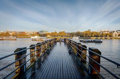 Pier over river against sky