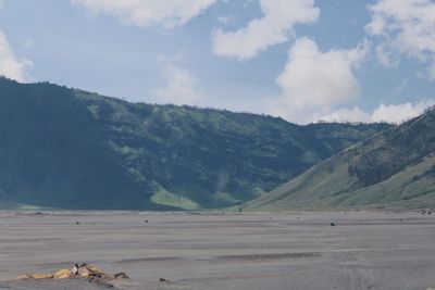 Scenic view of mountains against cloudy sky