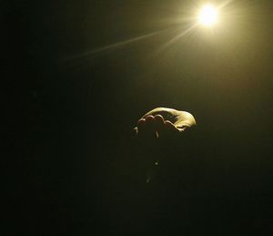 Close-up of illuminated light over black background